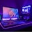 A gaming setup with a monitor displaying a colorful 'Republic of Gamers' logo, accompanied by a mechanical keyboard and a gaming mouse on a desk illuminated with RGB lighting. The computer tower is visible, featuring internal cooling fans lit with vibrant blue and purple LED lights.